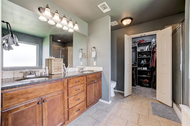 2500 SE 93rd St, Moore, OK 73160 - bathroom featuring a shower stall, double vanity, tile patterned flooring, and a spacious closet