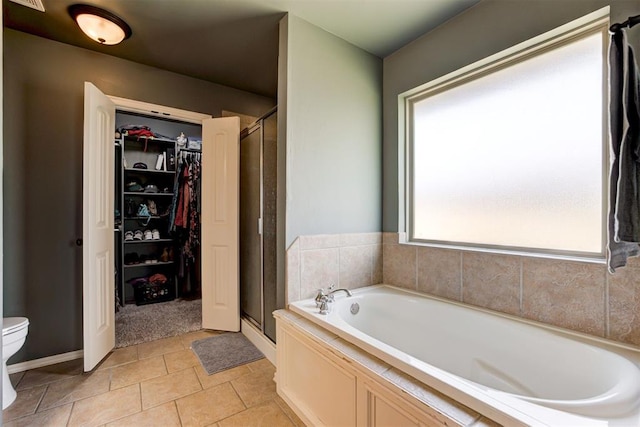 2500 SE 93rd St, Moore, OK 73160 - bathroom with a shower stall, a bath, a walk in closet, and tile patterned floors