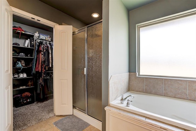 2500 SE 93rd St, Moore, OK 73160 - bathroom featuring a stall shower, a bath, a spacious closet, and tile patterned floors