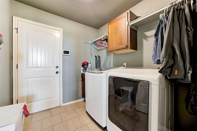 2500 SE 93rd St, Moore, OK 73160 - washroom featuring independent washer and dryer, cabinet space, and light tile patterned floors