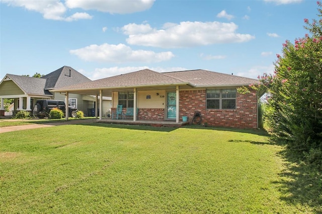 720 N Main St, Blanchard, OK 73010 - view of front of property featuring covered porch, a front lawn, driveway, brick siding, and an attached carport