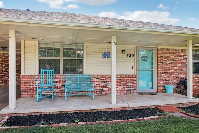 720 N Main St, Blanchard, OK 73010 - property entrance featuring brick siding and a porch