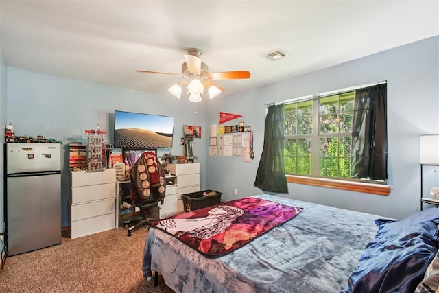 720 N Main St, Blanchard, OK 73010 - carpeted bedroom featuring freestanding refrigerator and a ceiling fan