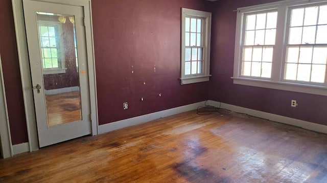 2609 NW 14th St, Oklahoma City, OK 73107 - spare room featuring healthy amount of natural light and wood finished floors