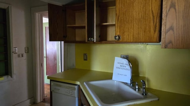 2609 NW 14th St, Oklahoma City, OK 73107 - kitchen with dishwasher, open shelves, light countertops, and brown cabinets