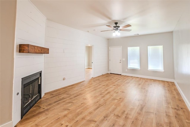 621 SW 7th St, Moore, OK 73160 - unfurnished living room with ceiling fan, a large fireplace, and light wood-style flooring