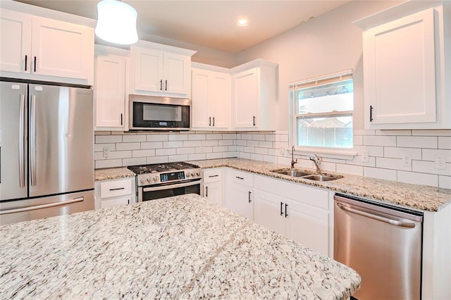 621 SW 7th St, Moore, OK 73160 - kitchen featuring stainless steel appliances, white cabinetry, decorative backsplash, light stone countertops, and recessed lighting