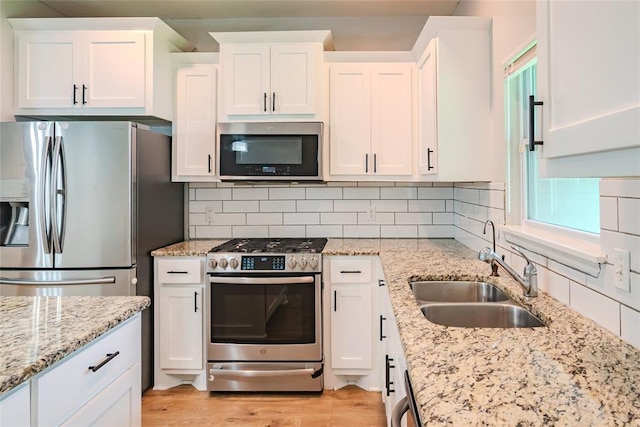 621 SW 7th St, Moore, OK 73160 - kitchen featuring stainless steel appliances, white cabinets, and decorative backsplash