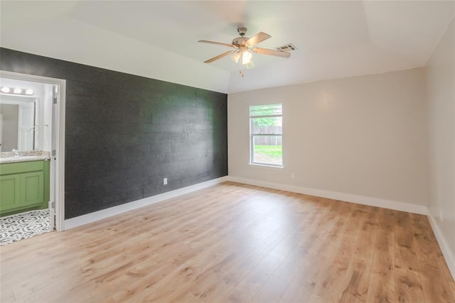 621 SW 7th St, Moore, OK 73160 - unfurnished room featuring light wood-type flooring, ceiling fan, and a tray ceiling