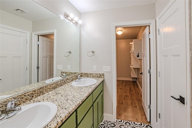 621 SW 7th St, Moore, OK 73160 - bathroom featuring double vanity and wood finished floors