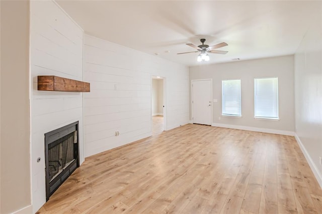 621 SW 7th St, Moore, OK 73160 - unfurnished living room featuring ceiling fan, a large fireplace, and light wood finished floors