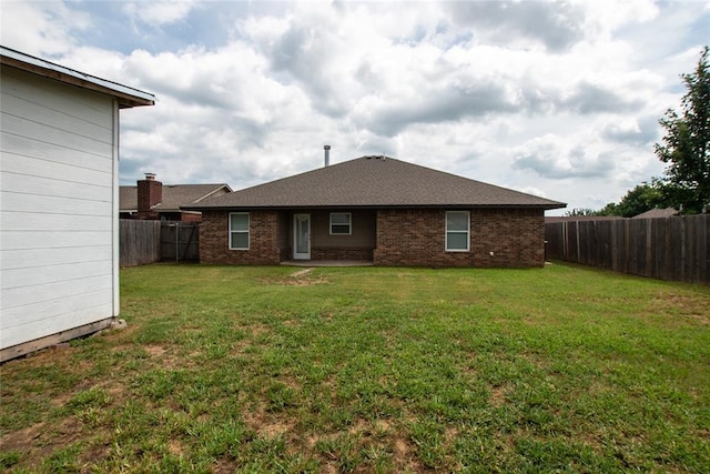 621 SW 7th St, Moore, OK 73160 - back of house featuring a fenced backyard and brick siding