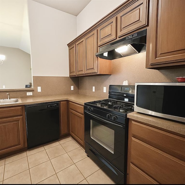 9524 SW 26th St, Oklahoma City, OK 73128 - kitchen featuring black appliances, under cabinet range hood, light tile patterned flooring, light countertops, and lofted ceiling