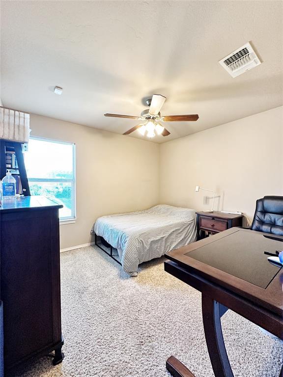 9524 SW 26th St, Oklahoma City, OK 73128 - bedroom with a ceiling fan and carpet