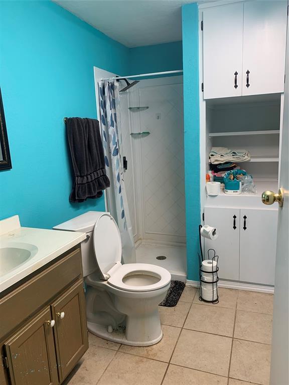 123 N Payne St, Fort Cobb, OK 73038 - bathroom with vanity, a shower stall, and tile patterned floors