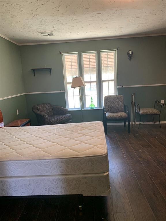 123 N Payne St, Fort Cobb, OK 73038 - bedroom with dark wood-type flooring, crown molding, and a textured ceiling