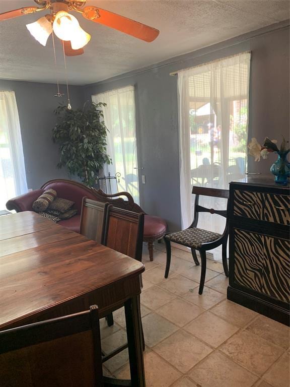 123 N Payne St, Fort Cobb, OK 73038 - dining area with ceiling fan, a textured ceiling, and light tile patterned floors