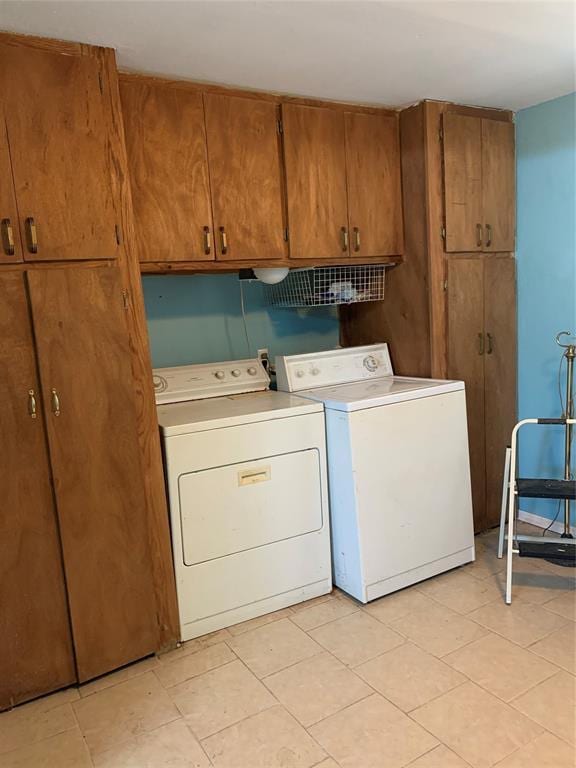 123 N Payne St, Fort Cobb, OK 73038 - washroom with washing machine and dryer, cabinet space, and light tile patterned floors