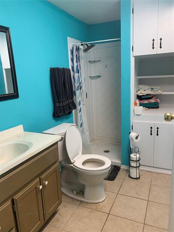 123 N Payne St, Fort Cobb, OK 73038 - full bath with vanity, tile patterned flooring, and a shower stall