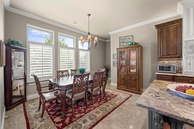 2725 Open Range Rd, Edmond, OK 73034 - dining area featuring a chandelier and ornamental molding