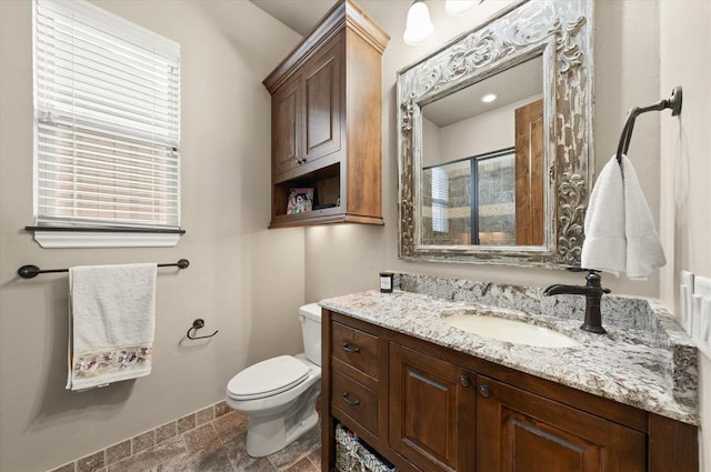 2725 Open Range Rd, Edmond, OK 73034 - full bathroom with stone tile floors, vanity, healthy amount of natural light, and a shower