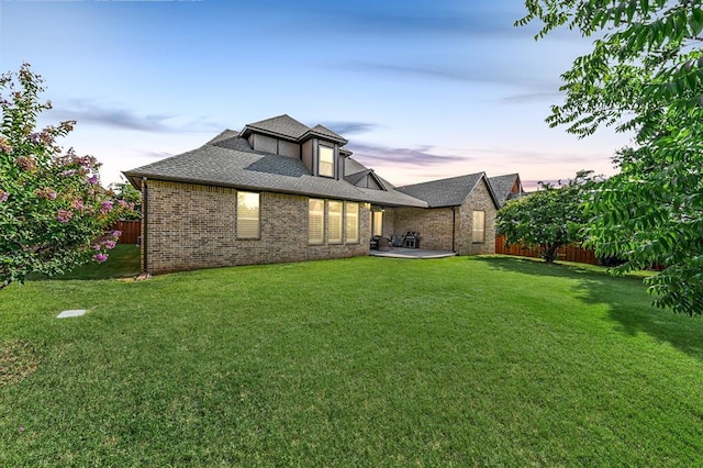 2725 Open Range Rd, Edmond, OK 73034 - rear view of property with a fenced backyard, brick siding, a patio area, and a shingled roof