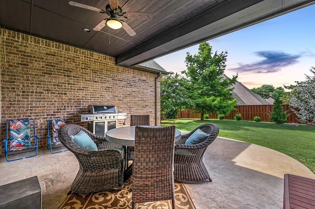 2725 Open Range Rd, Edmond, OK 73034 - fenced backyard with ceiling fan, a patio area, outdoor dining space, and area for grilling