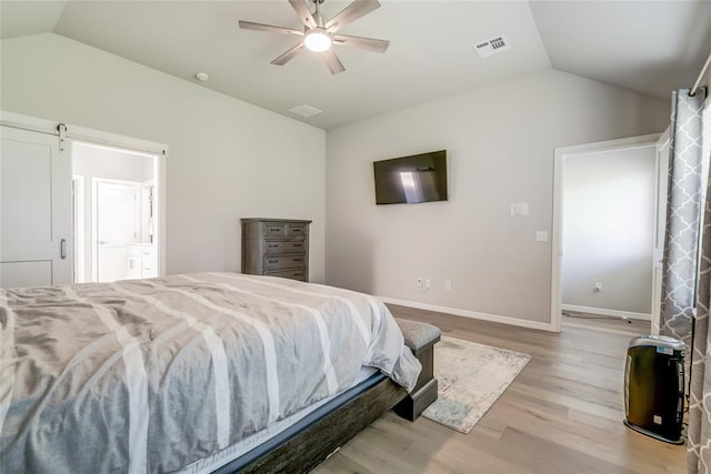 6605 NW 150th Ter, Oklahoma City, OK 73142 - bedroom with vaulted ceiling, light wood-style flooring, ceiling fan, and ensuite bath