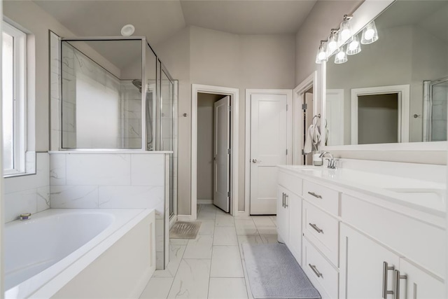 6605 NW 150th Ter, Oklahoma City, OK 73142 - full bathroom featuring a garden tub, a shower stall, double vanity, and marble finish flooring