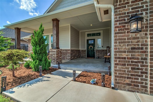 6605 NW 150th Ter, Oklahoma City, OK 73142 - doorway to property with brick siding and a porch
