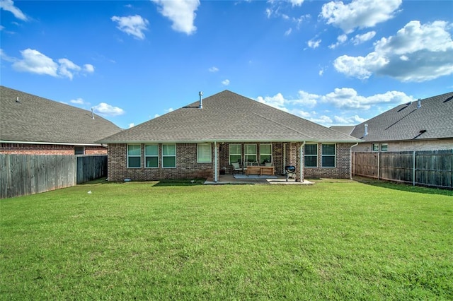 6605 NW 150th Ter, Oklahoma City, OK 73142 - rear view of house featuring a patio, brick siding, a fenced backyard, and roof with shingles