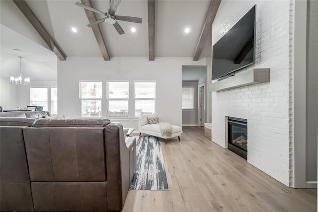6605 NW 150th Ter, Oklahoma City, OK 73142 - living area with a ceiling fan, light wood-style floors, a fireplace, a chandelier, and recessed lighting