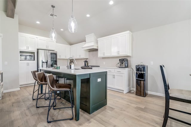 6605 NW 150th Ter, Oklahoma City, OK 73142 - kitchen featuring custom range hood, appliances with stainless steel finishes, decorative backsplash, a kitchen breakfast bar, and light countertops