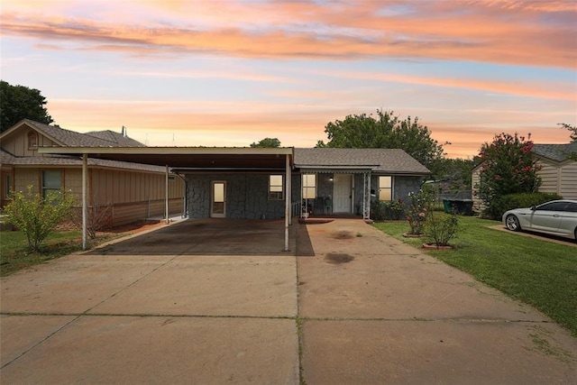 329 SE 58th St, Oklahoma City, OK 73129 - view of front of property with driveway, a lawn, and stone siding