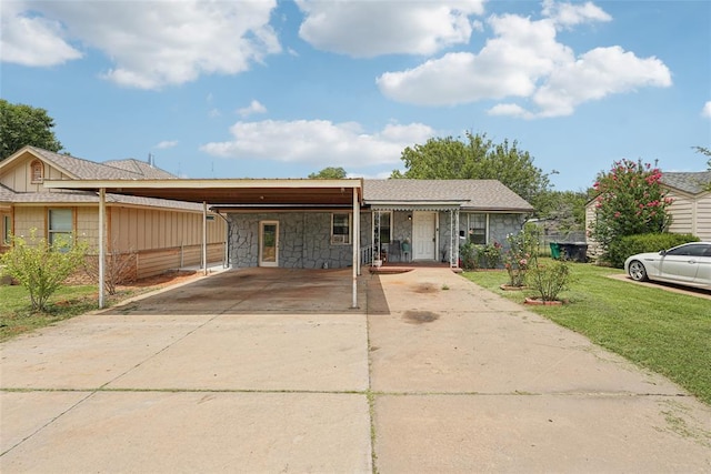 329 SE 58th St, Oklahoma City, OK 73129 - single story home featuring stone siding, driveway, a front yard, and an attached carport