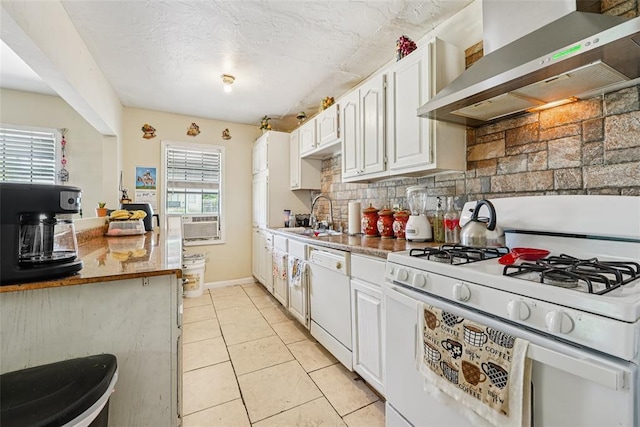 329 SE 58th St, Oklahoma City, OK 73129 - kitchen featuring wall chimney range hood, white appliances, white cabinets, tasteful backsplash, and light tile patterned flooring