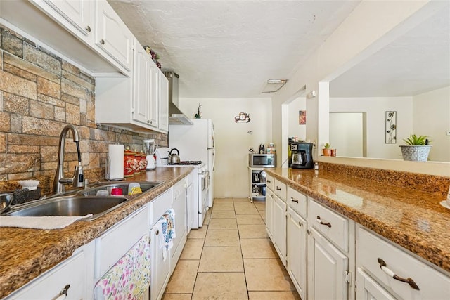 329 SE 58th St, Oklahoma City, OK 73129 - kitchen featuring stainless steel microwave, white cabinets, gas range gas stove, tasteful backsplash, and wall chimney exhaust hood