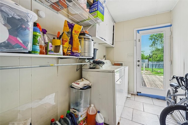 329 SE 58th St, Oklahoma City, OK 73129 - laundry room with cabinet space, washer and clothes dryer, and light tile patterned floors