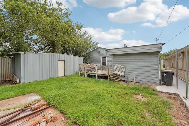 329 SE 58th St, Oklahoma City, OK 73129 - view of grassy yard featuring a wooden deck and an outdoor structure