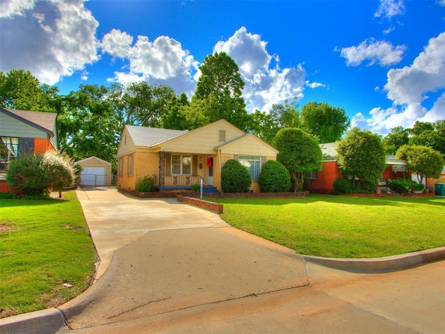 5409 N Walker Ave, Oklahoma City, OK 73118 - view of front facade with covered porch, an outdoor structure, a front yard, and driveway