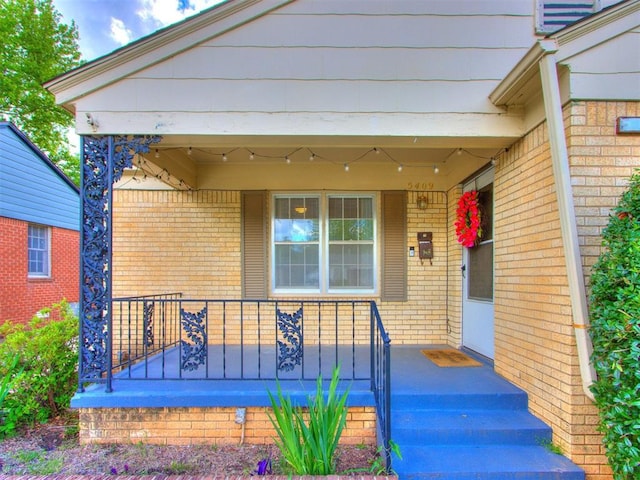 5409 N Walker Ave, Oklahoma City, OK 73118 - property entrance with a porch and brick siding