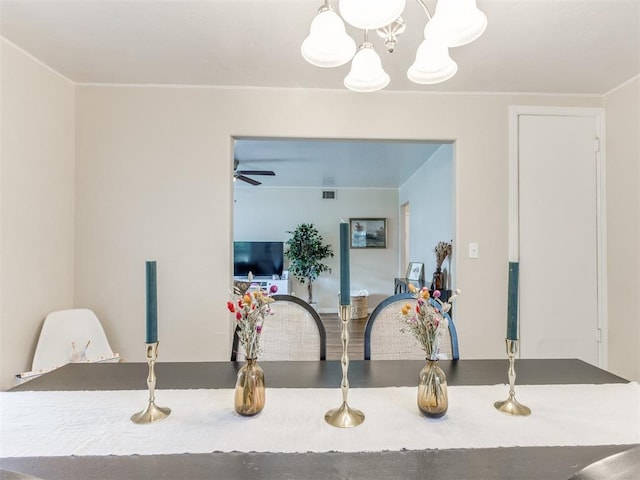 5409 N Walker Ave, Oklahoma City, OK 73118 - dining space with a chandelier, a ceiling fan, and crown molding