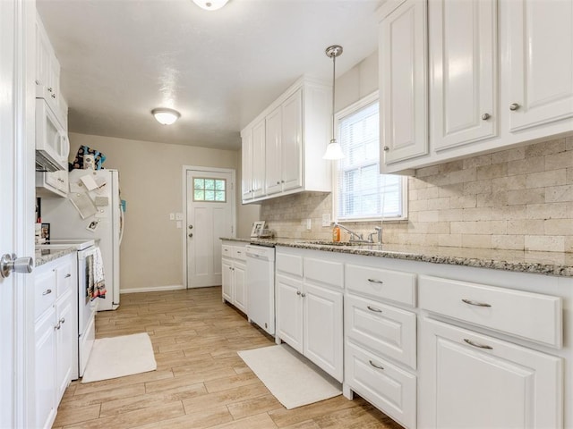 5409 N Walker Ave, Oklahoma City, OK 73118 - kitchen featuring white appliances, white cabinetry, light wood-style floors, backsplash, and light stone countertops