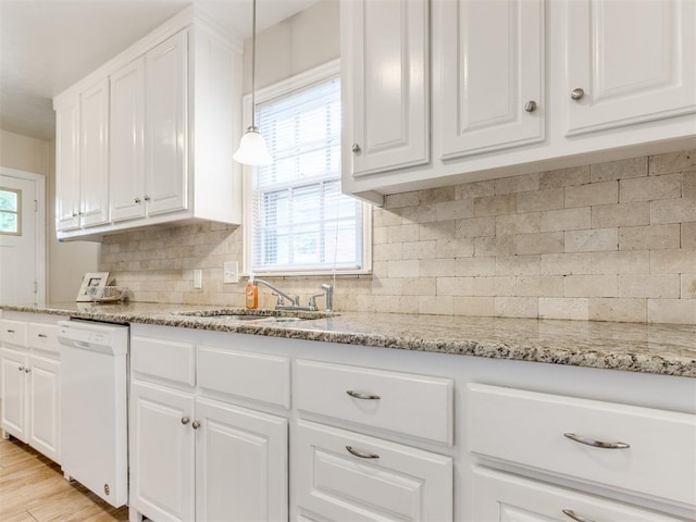 5409 N Walker Ave, Oklahoma City, OK 73118 - kitchen featuring white dishwasher, healthy amount of natural light, white cabinetry, and light stone counters