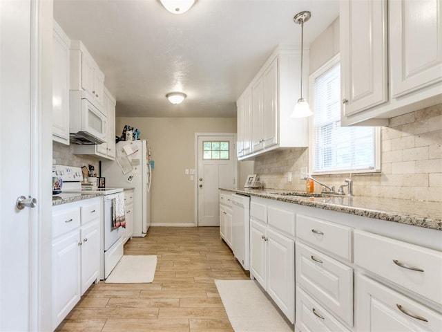 5409 N Walker Ave, Oklahoma City, OK 73118 - kitchen featuring white appliances, white cabinets, light wood finished floors, tasteful backsplash, and light stone countertops