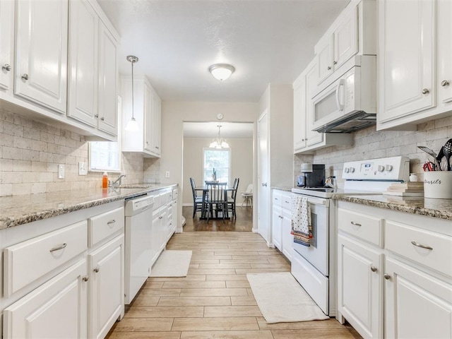 5409 N Walker Ave, Oklahoma City, OK 73118 - kitchen featuring white appliances, white cabinetry, and backsplash