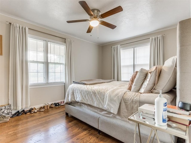 5409 N Walker Ave, Oklahoma City, OK 73118 - bedroom with multiple windows, wood finished floors, ceiling fan, and crown molding