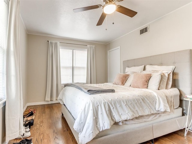 5409 N Walker Ave, Oklahoma City, OK 73118 - bedroom with wood finished floors, ornamental molding, and ceiling fan