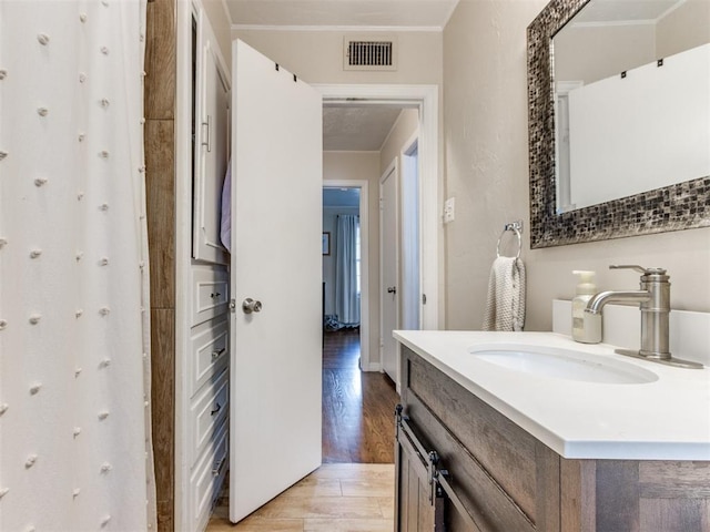 5409 N Walker Ave, Oklahoma City, OK 73118 - bathroom with wood finished floors and vanity