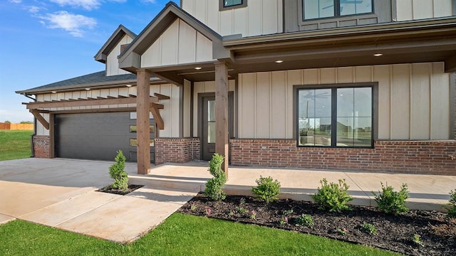 4676 Ranchero Dr, Edmond, OK 73025 - view of front facade featuring brick siding, an attached garage, concrete driveway, and board and batten siding